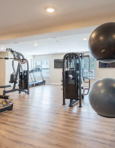 Gym Features Various Equipment And Windows