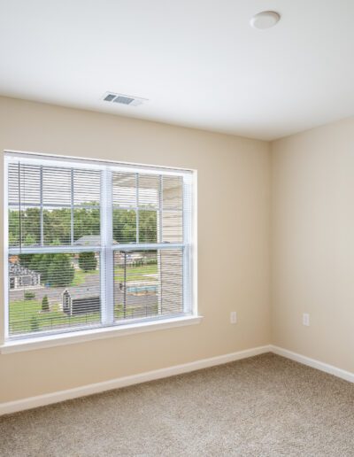 Room Features Large Window And White Blinds